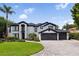 Elegant two-story home boasting a three-car garage, paver driveway, and professionally landscaped yard at 904 Main St, Windermere, FL 34786