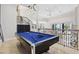 Upstairs game room with a billiards table, wrought iron railing and view of the living room at 904 Main St, Windermere, FL 34786