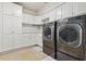 Well-equipped laundry room with modern washer and dryer and ample cabinet space at 904 Main St, Windermere, FL 34786