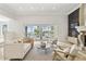 Living room with neutral furniture, high ceilings, and sliding glass doors to the patio at 904 Main St, Windermere, FL 34786