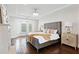 Luxurious main bedroom with hardwood floors, a sitting area, and a stylish chandelier at 904 Main St, Windermere, FL 34786