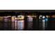 Festive boat parade at night with colorful lights reflecting on the calm lake water at 904 Main St, Windermere, FL 34786