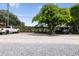 Parking area with gravel, mature trees and parking for multiple vehicles at 904 Main St, Windermere, FL 34786