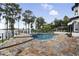 Backyard pool overlooking the lake, with stone pavers, mature trees, and lounging area at 904 Main St, Windermere, FL 34786