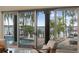 Living area view of a patio with a pool overlooking a lake, framed by large sliding glass doors at 904 Main St, Windermere, FL 34786