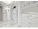 Bright, spacious walk-in closet with custom shelving and mirrored cabinets at 904 Main St, Windermere, FL 34786