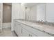 Bathroom featuring double vanity, granite countertop, and tiled shower/bath at 487 Toscano St, Clermont, FL 34715