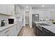 Modern kitchen boasts stainless steel appliances, granite countertops, and ample cabinet space at 487 Toscano St, Clermont, FL 34715