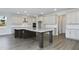 Spacious kitchen with a large island, stainless steel appliances, and plenty of cabinet space at 487 Toscano St, Clermont, FL 34715