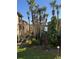 Building exterior with lush tropical landscaping and palm trees with waterfront view at 588 Orange Dr # 131, Altamonte Springs, FL 32701