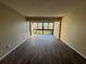 Spacious, bright room with a sliding glass door, neutral paint, and a plank tile floor at 588 Orange Dr # 131, Altamonte Springs, FL 32701