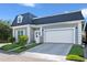 Gray house with white garage and landscaping at 900 Sussex Close, Orlando, FL 32804