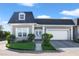 Gray house with white garage door and landscaping at 900 Sussex Close, Orlando, FL 32804
