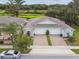 Aerial view of the home featuring a lush lawn and landscaping with pond view at 1862 Overcup Ave, Saint Cloud, FL 34771