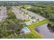 Aerial view of homes, a community pool, pond, and lush greenery in a well-maintained neighborhood at 1862 Overcup Ave, Saint Cloud, FL 34771