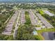 Aerial view of a well-maintained neighborhood with homes, greenery, community pool and pond at 1862 Overcup Ave, Saint Cloud, FL 34771