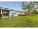 Exterior view of home featuring lush lawn, landscaping, and screened-in porch at 1862 Overcup Ave, Saint Cloud, FL 34771