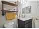 Close-up bathroom view showcasing a sink, mirror, and rustic shelving unit at 1862 Overcup Ave, Saint Cloud, FL 34771