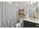 Bathroom showcasing a shower, vanity with sink, and shelving unit at 1862 Overcup Ave, Saint Cloud, FL 34771