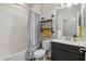 Bathroom featuring a tub with shower, vanity with sink, and decorative shelving at 1862 Overcup Ave, Saint Cloud, FL 34771