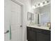 Well-lit bathroom featuring a double vanity with dark cabinets and neutral countertops at 1862 Overcup Ave, Saint Cloud, FL 34771