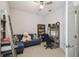 Well-lit bedroom features a blue sofa, bookshelf, desk and decor, providing a cozy study or relaxation area at 1862 Overcup Ave, Saint Cloud, FL 34771