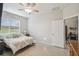 Primary bedroom featuring a bright window, ceiling fan, and an ensuite bathroom at 1862 Overcup Ave, Saint Cloud, FL 34771