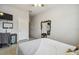 Bright bedroom featuring an ivy-lined mirror, mounted TV, and ensuite bathroom at 1862 Overcup Ave, Saint Cloud, FL 34771