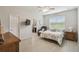 Primary bedroom featuring bright window, ceiling fan, and ensuite bathroom at 1862 Overcup Ave, Saint Cloud, FL 34771