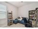 Cozy bedroom offers a blue sofa, bookshelf, desk and a serene space for relaxation and study at 1862 Overcup Ave, Saint Cloud, FL 34771