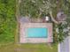 Aerial view of the community pool with lounge chairs and adjacent covered lounge area at 1862 Overcup Ave, Saint Cloud, FL 34771