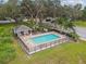 The community pool features a cabana, patio seating and mature shade trees at 1862 Overcup Ave, Saint Cloud, FL 34771