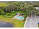 Aerial view of the community pool and cabana in a lush, green setting with mature trees and landscaping at 1862 Overcup Ave, Saint Cloud, FL 34771