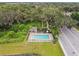 Aerial view of the community pool and cabana in a lush, green setting with mature trees and landscaping at 1862 Overcup Ave, Saint Cloud, FL 34771