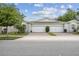 Inviting villa with a brick-paved driveway and a two-car garage, exuding suburban charm at 1862 Overcup Ave, Saint Cloud, FL 34771