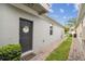 Exterior shot of front door featuring a welcome mat, wreath, and manicured bushes at 1862 Overcup Ave, Saint Cloud, FL 34771