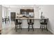 Open kitchen featuring bar stool seating at the granite countertop island and stainless steel appliances at 1862 Overcup Ave, Saint Cloud, FL 34771