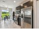 Bright kitchen boasts stainless steel appliances, dark cabinetry, and a dining area with a view of the backyard at 1862 Overcup Ave, Saint Cloud, FL 34771