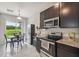 The kitchen features modern appliances and a dining nook with backyard views, plus stylish dark cabinets at 1862 Overcup Ave, Saint Cloud, FL 34771