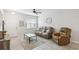 Cozy living room showcasing tile flooring, a ceiling fan, and comfortable furniture near the front entrance at 1862 Overcup Ave, Saint Cloud, FL 34771