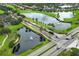 An aerial view of a community featuring ponds, golf course, palm trees, and well-maintained landscaping at 14126 Fox Glove St, Winter Garden, FL 34787