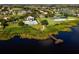 Aerial view of community amenities including a pool, playground, sports courts, and dock on a scenic lake at 14126 Fox Glove St, Winter Garden, FL 34787
