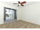 A bright bedroom with neutral carpet features a ceiling fan and sliding doors to a screened porch at 14126 Fox Glove St, Winter Garden, FL 34787