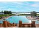 Beautiful community pool with sun loungers overlooking a serene lake at 14126 Fox Glove St, Winter Garden, FL 34787