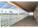 A spacious wooden deck overlooks the lake and the home's enclosed pool area at 14126 Fox Glove St, Winter Garden, FL 34787