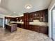 Large kitchen boasting dark wood cabinetry, stainless steel appliances, and a spacious center island at 14126 Fox Glove St, Winter Garden, FL 34787