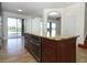 Gourmet kitchen island with stainless oven, wood cabinetry, and granite countertop, overlooking water at 14126 Fox Glove St, Winter Garden, FL 34787