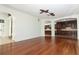 Spacious living room with hardwood floors, ceiling fan, and open access to the kitchen and front entryway at 14126 Fox Glove St, Winter Garden, FL 34787