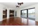 Open living room featuring hardwood floors, ceiling fans, and sliding glass doors leading to the pool at 14126 Fox Glove St, Winter Garden, FL 34787