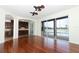 The living room with hardwood floors features large windows with access to a screened-in pool area at 14126 Fox Glove St, Winter Garden, FL 34787
